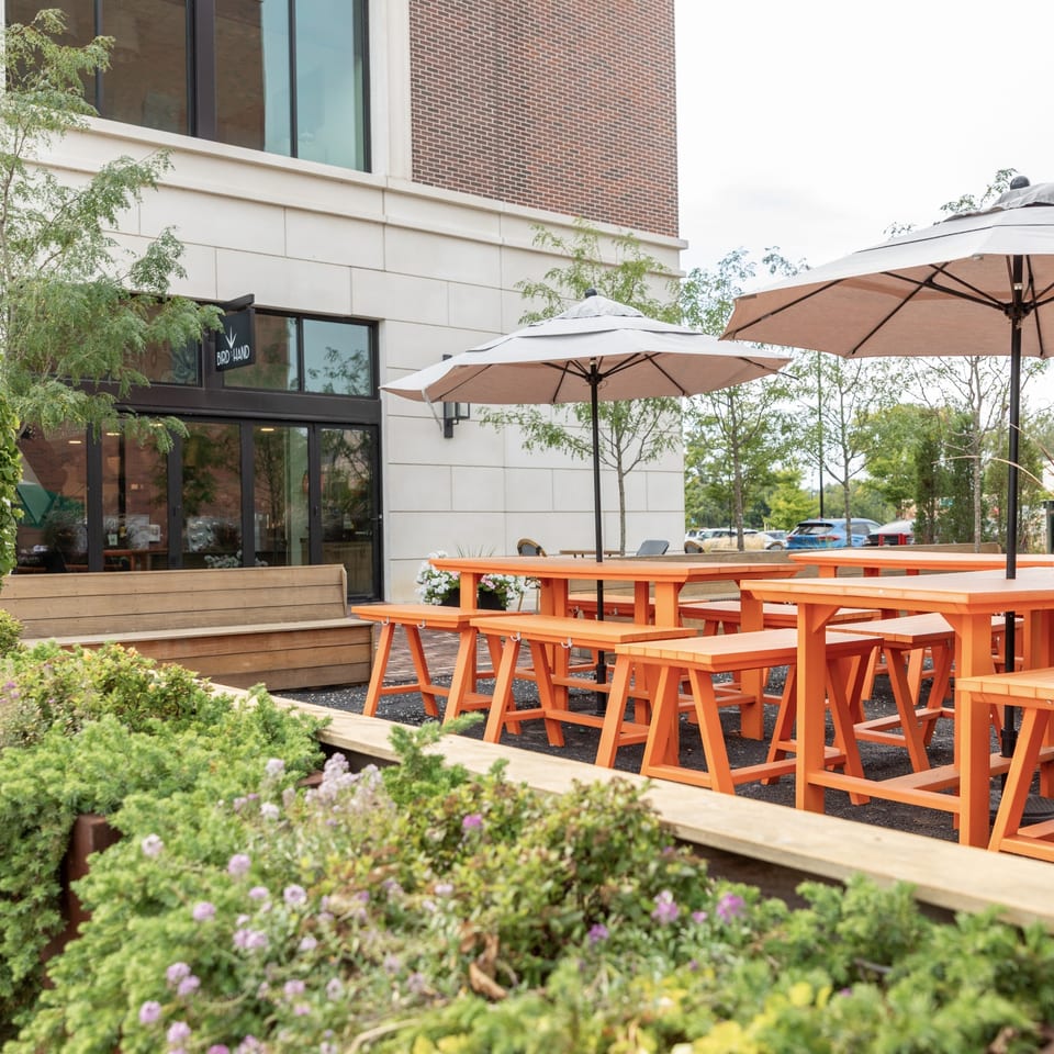 Outdoor patio with orange picnic tables